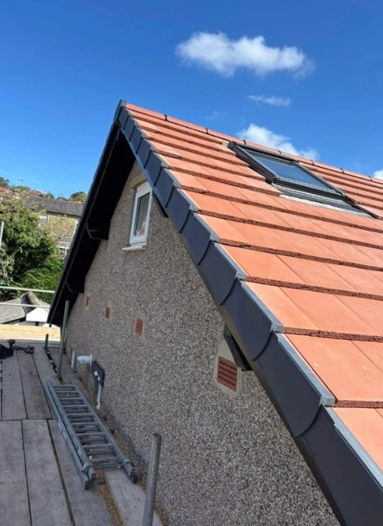 Dry ridge and dry verge system fitted to a new red tiled roof